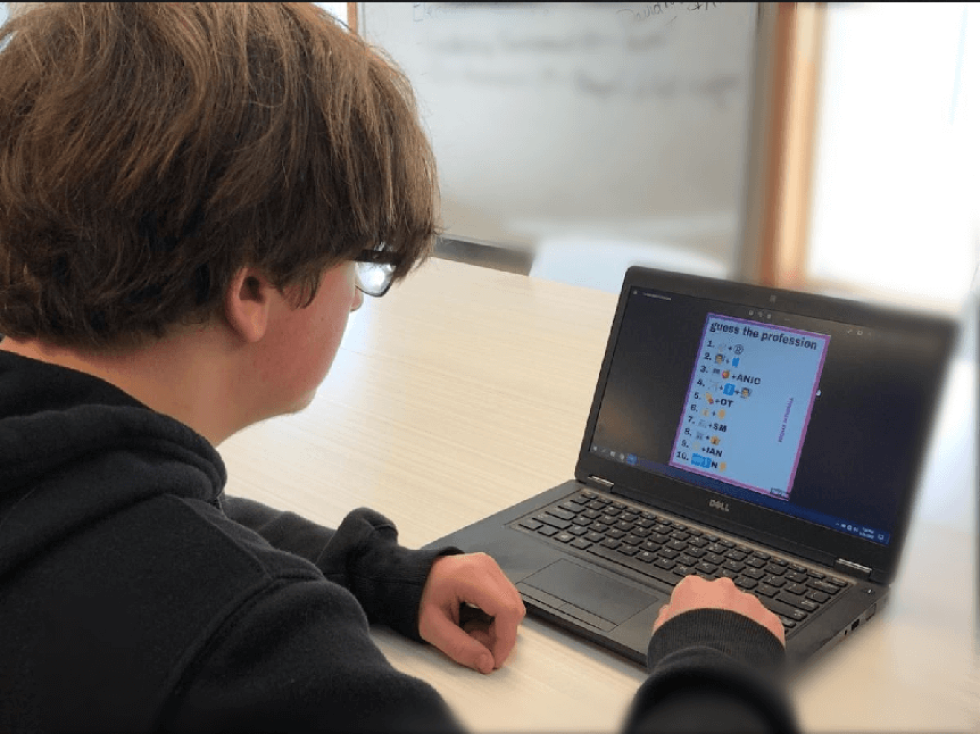 Cardinal CSD student in Education Talent Search program on his computer.